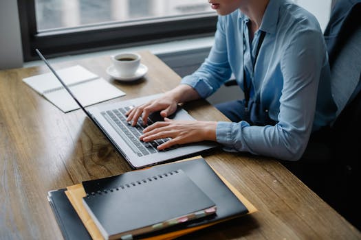 Image of a busy professional enjoying coffee while working