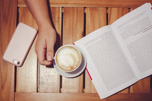 A person studying with a coffee cup and notes on the table